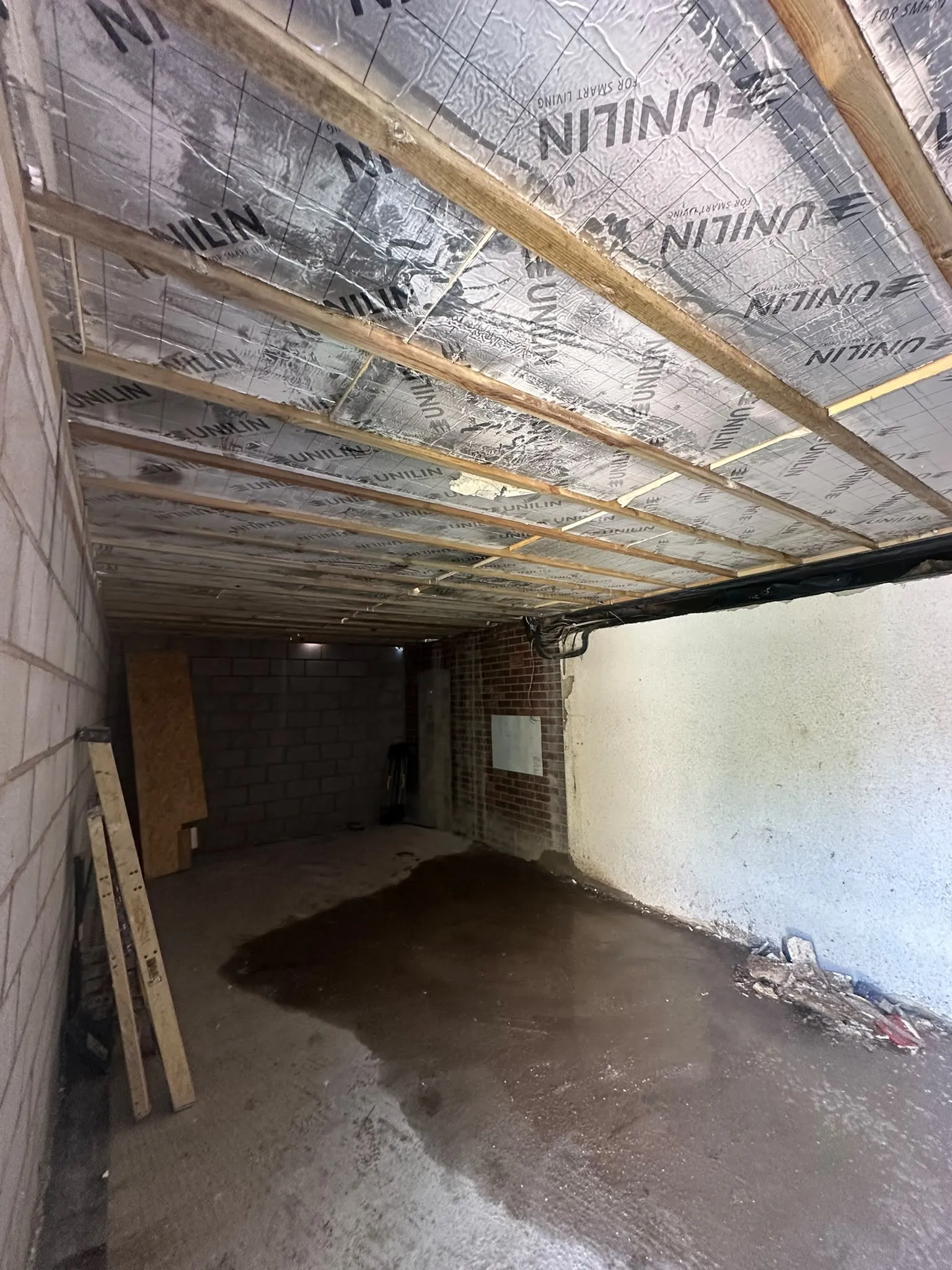 Inside a garage with new insulation boards fixed across the ceiling