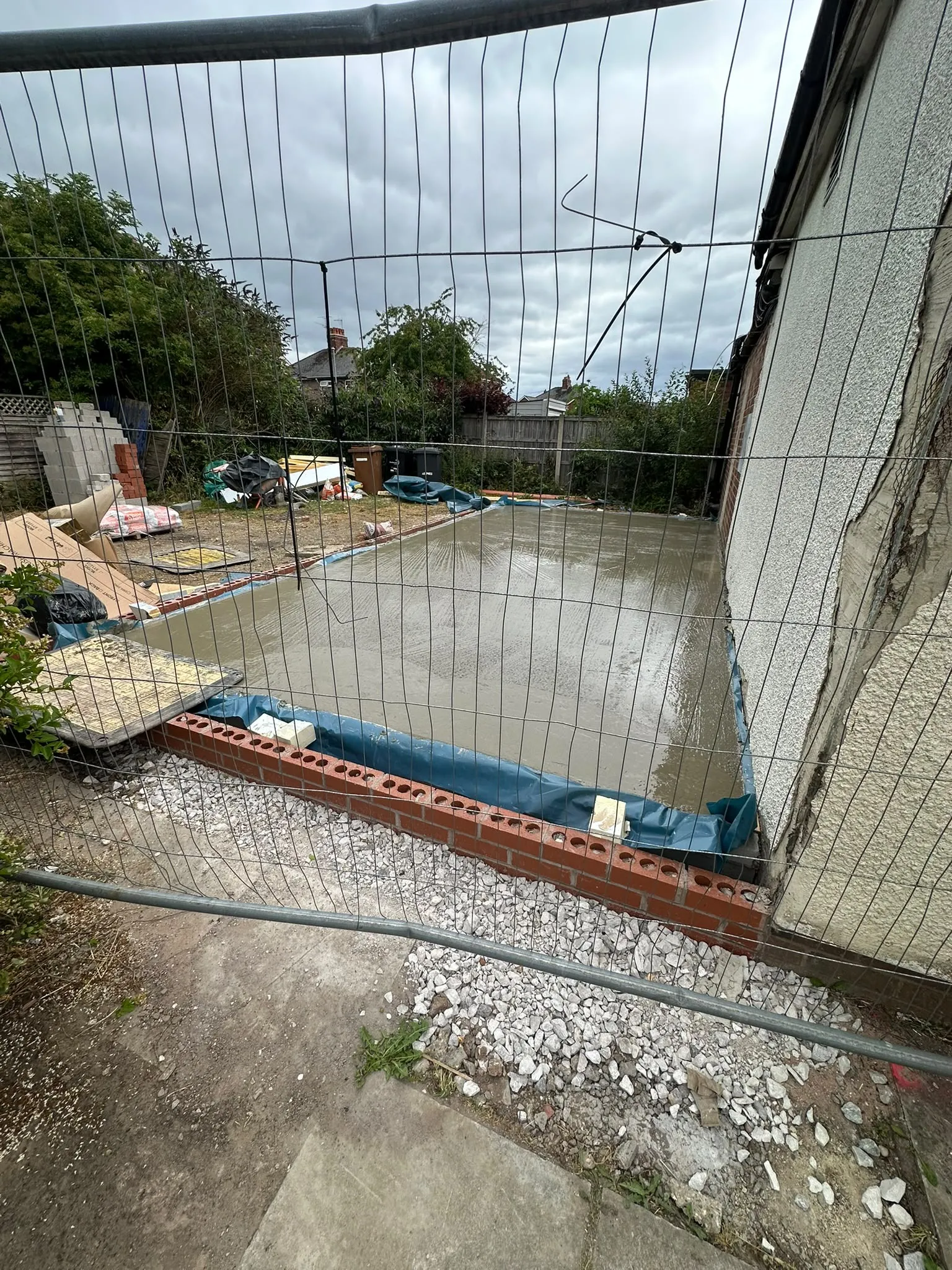 Freshly poured concrete slab inside a brick edge