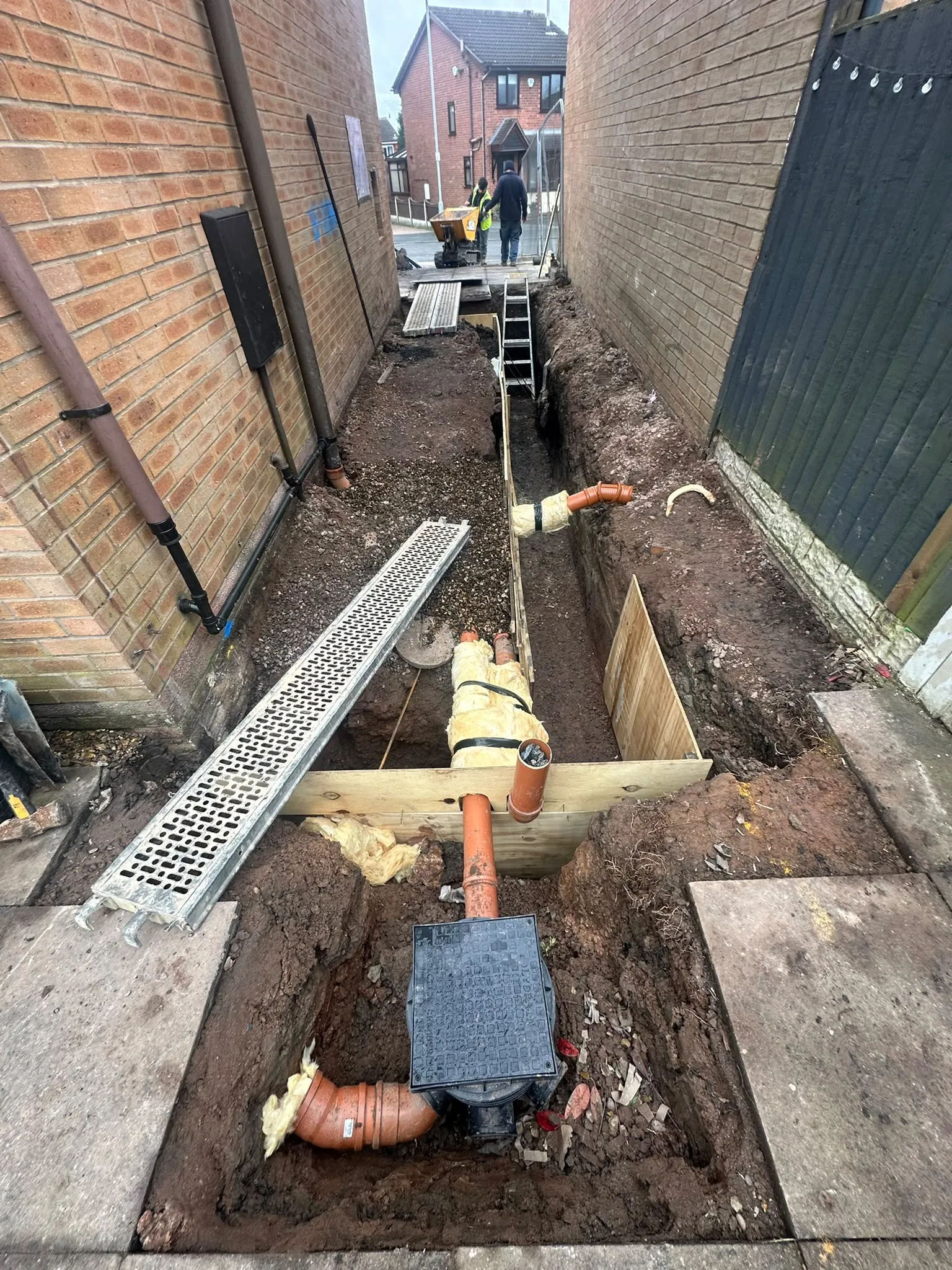 New drainage pipes and an inspection chamber in a trench
