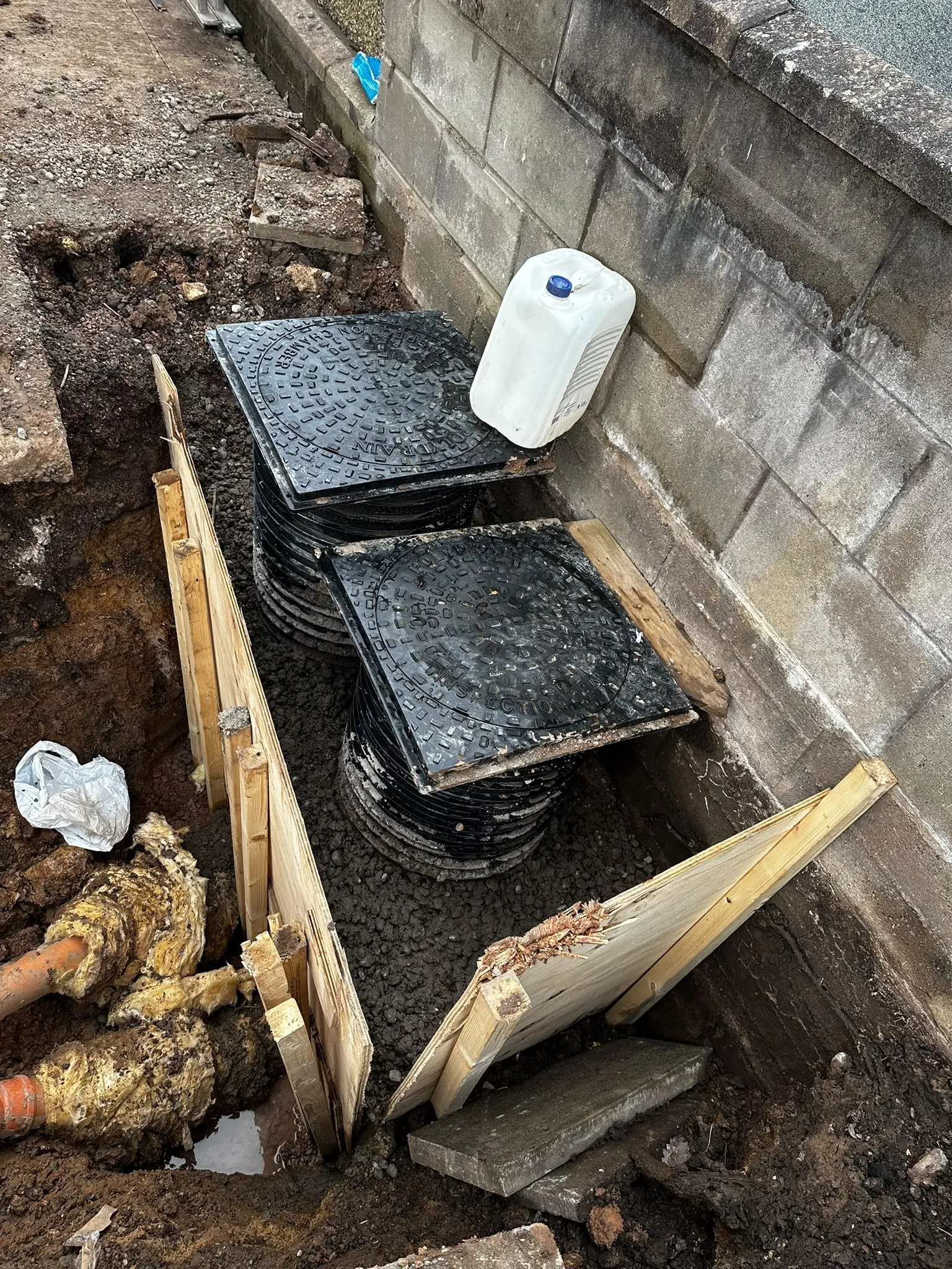 New drainage inspection chambers being fitted in a trench