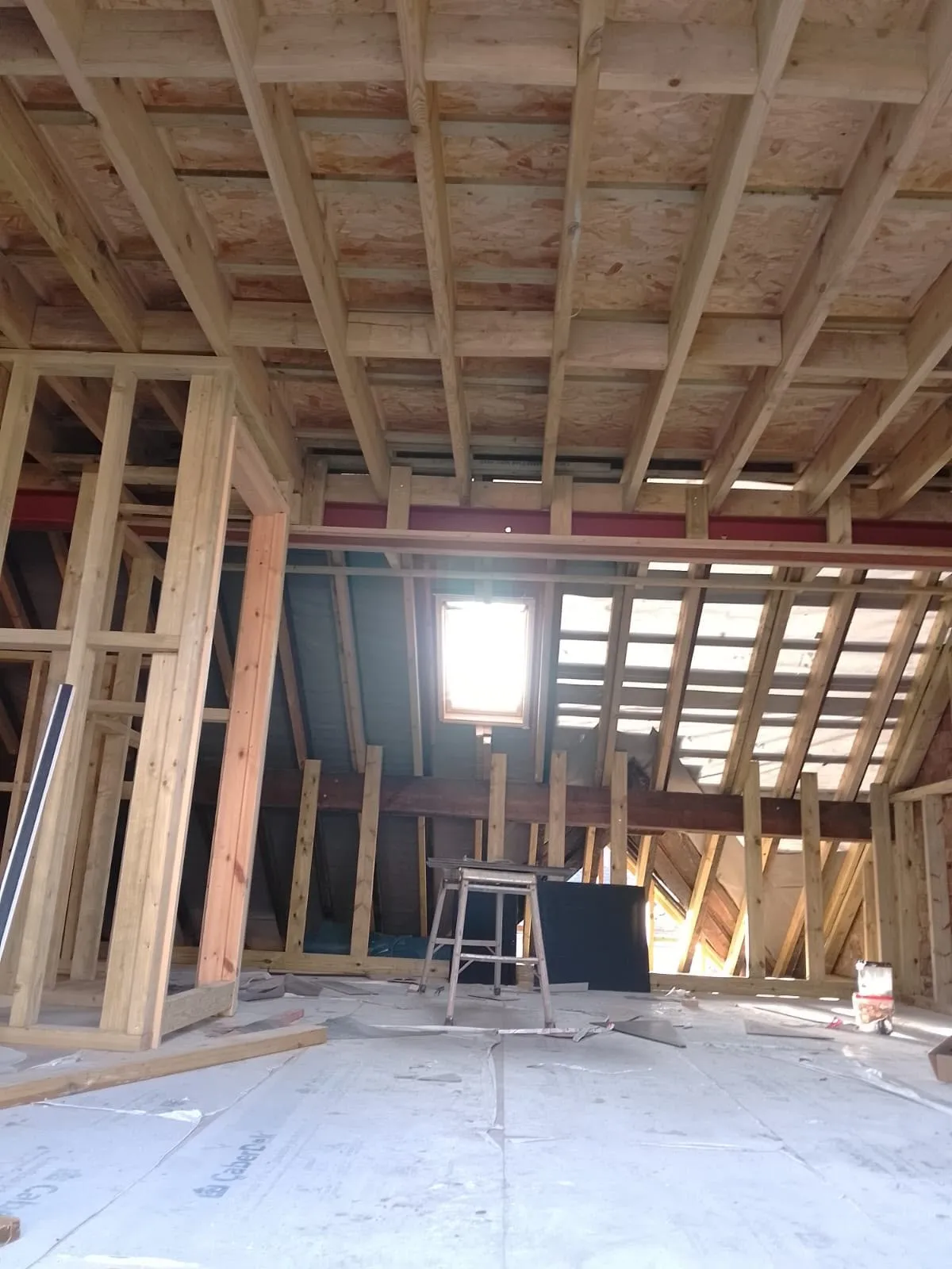 Large loft room with new timber framing and a roof window letting in light