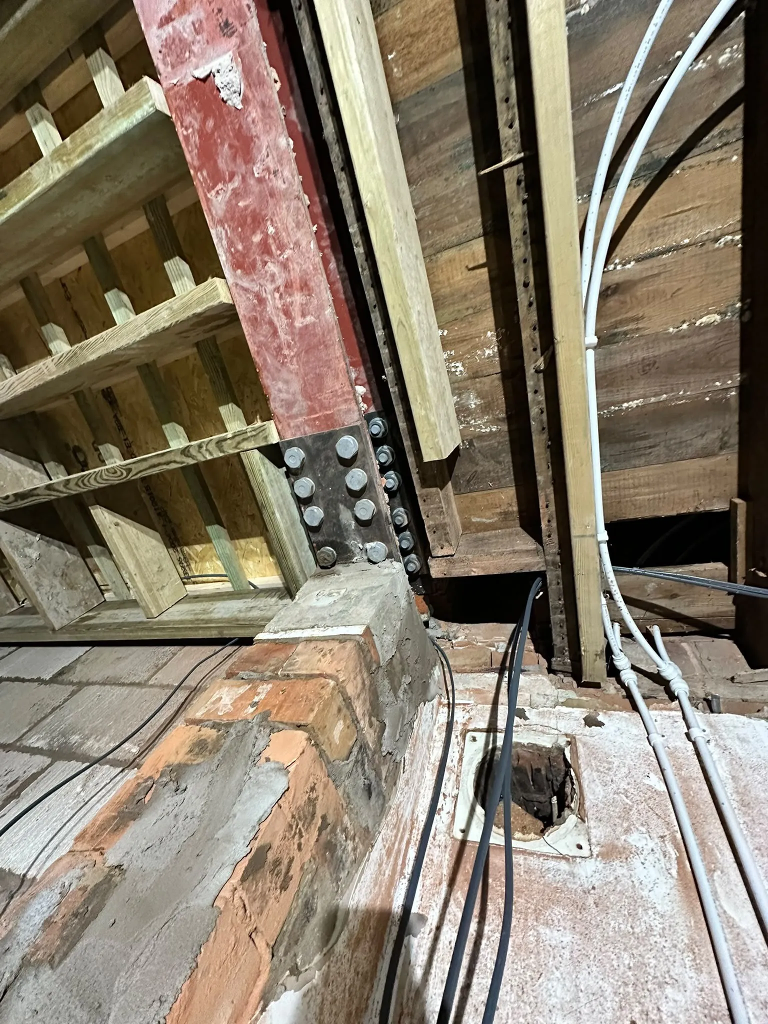 New steel beam resting on brickwork inside a loft