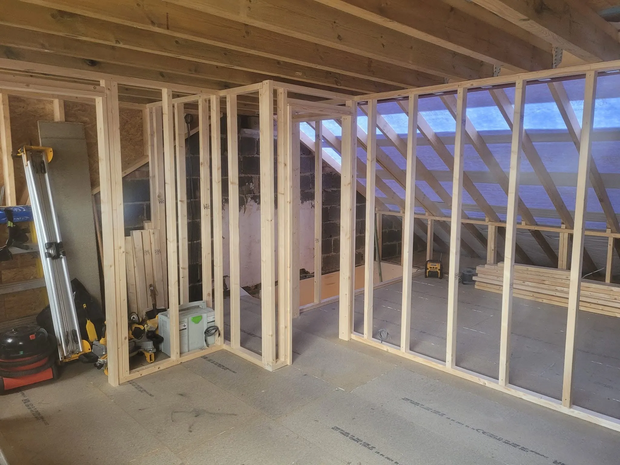New stud walls dividing a loft into rooms under the roof