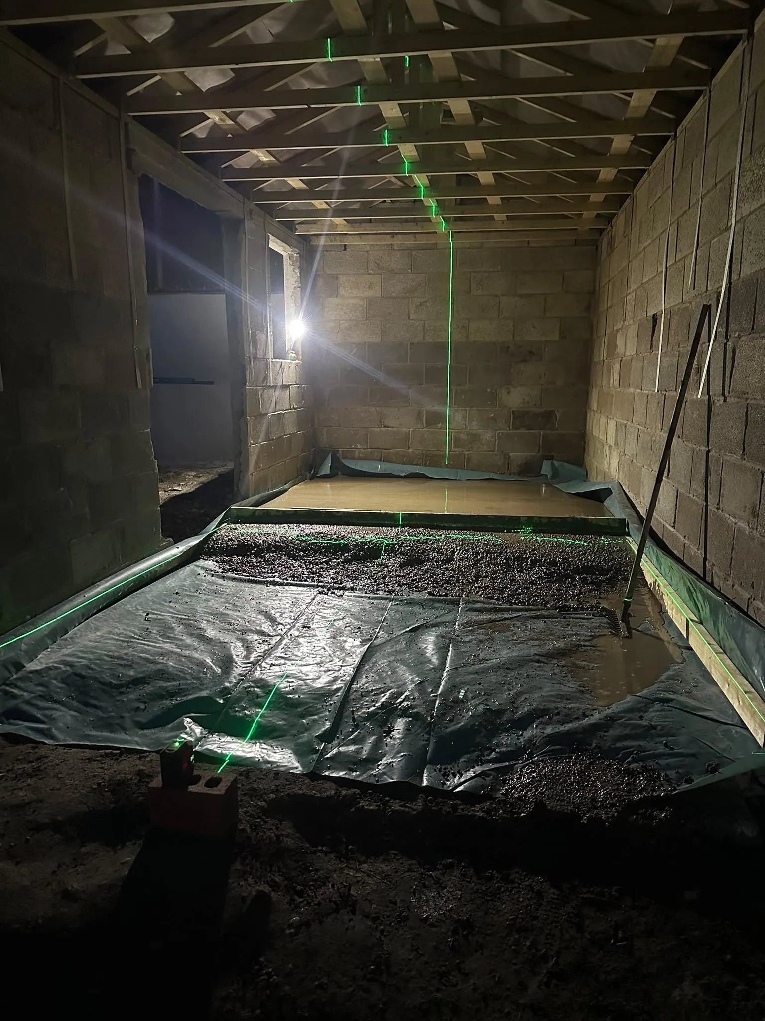 Inside a new blockwork building with a membrane laid ready for the floor
