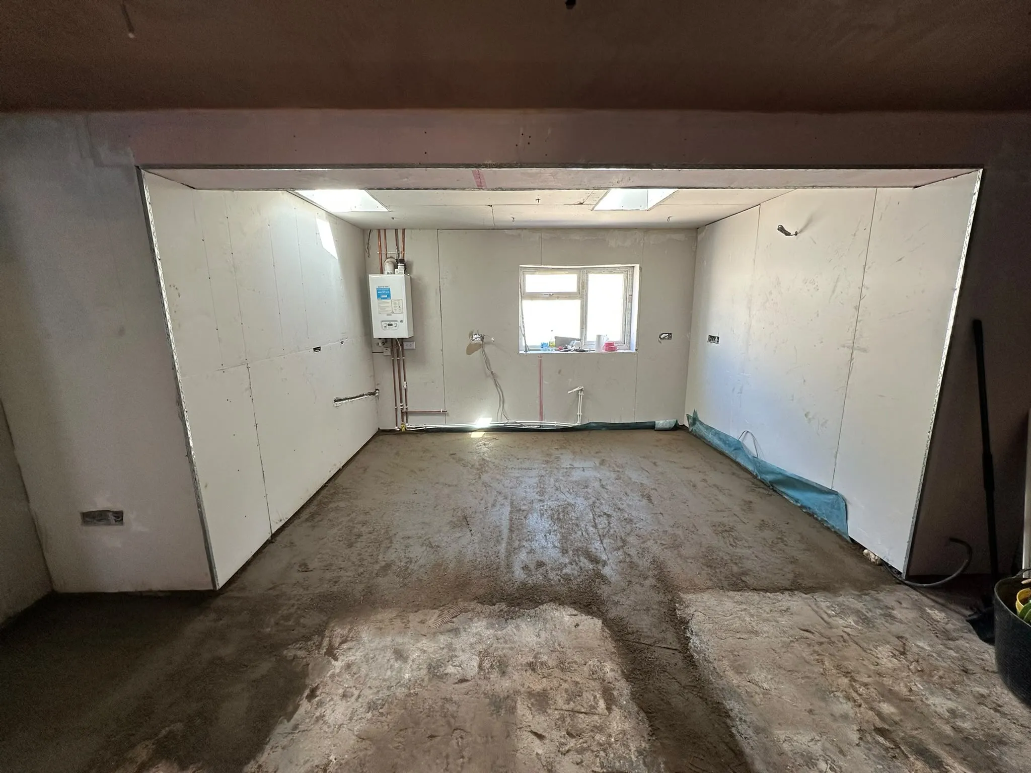 Room with new plasterboard walls and a fresh screed floor