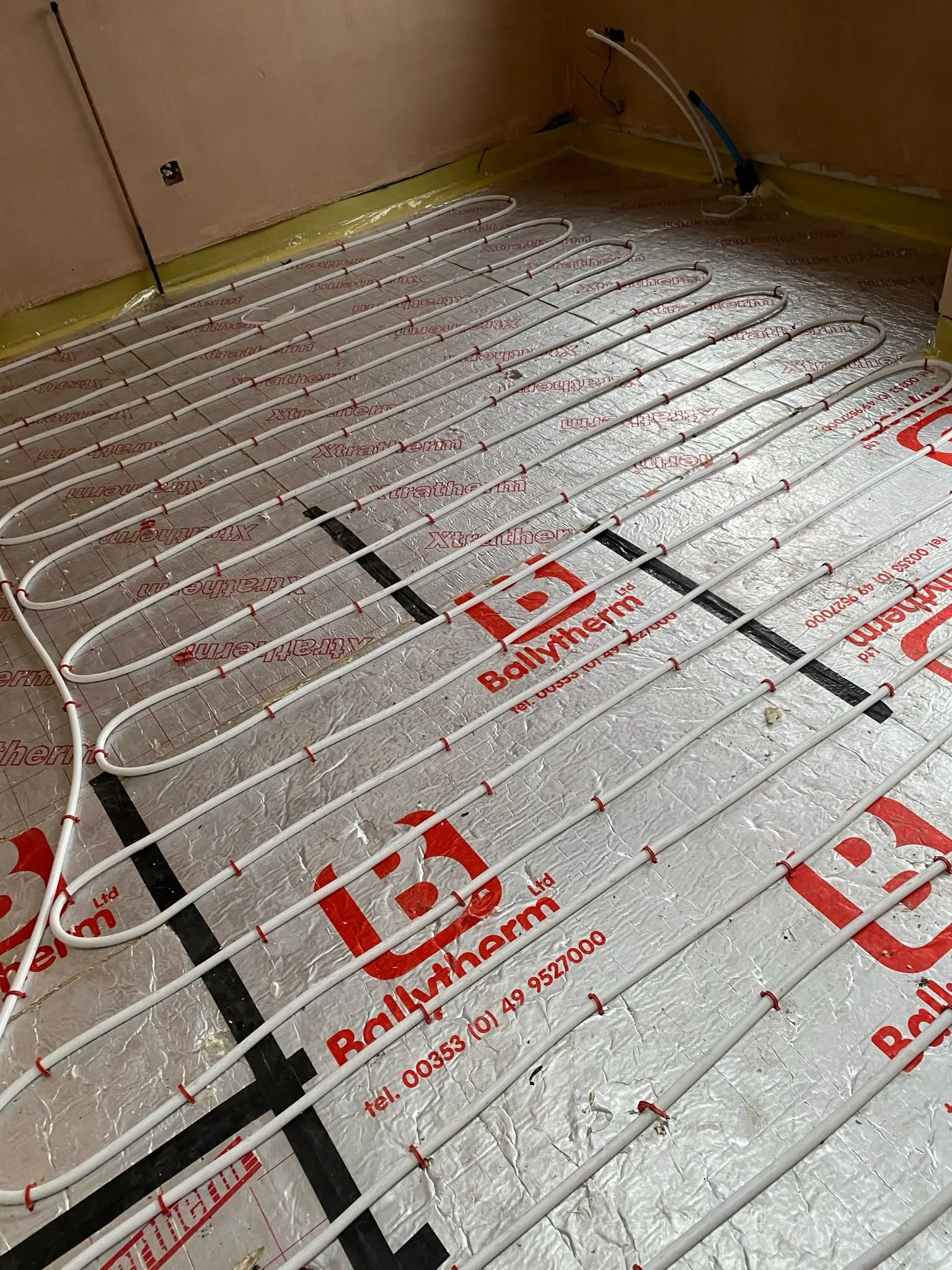 Underfloor heating pipes laid over insulation boards