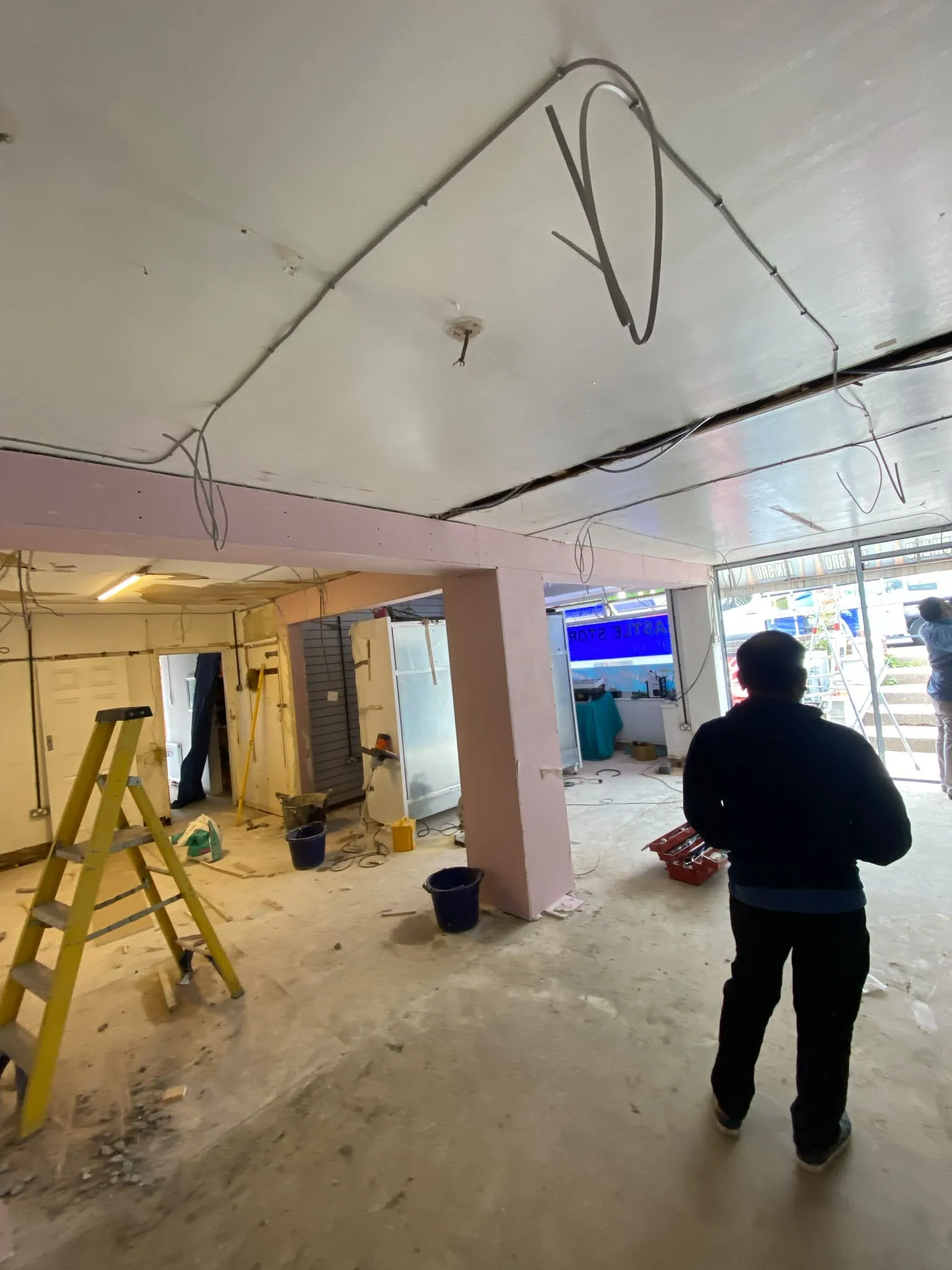 Commercial unit being refurbished, with new ceiling and opened-up rooms