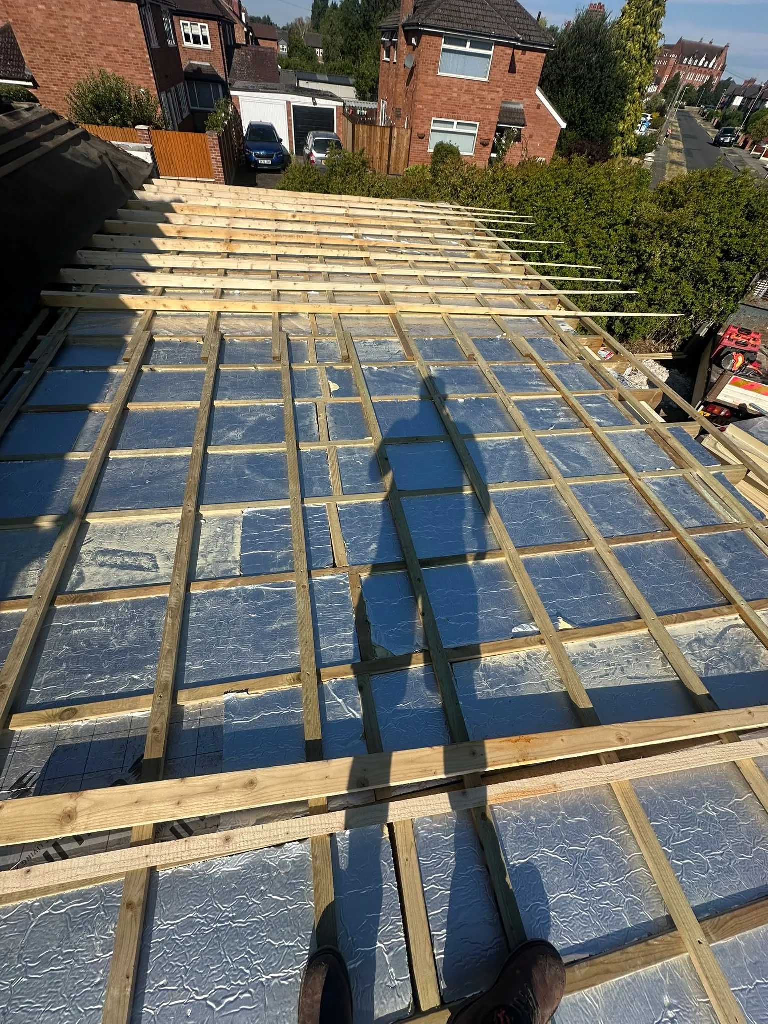 Insulation boards between timber joists on a flat roof