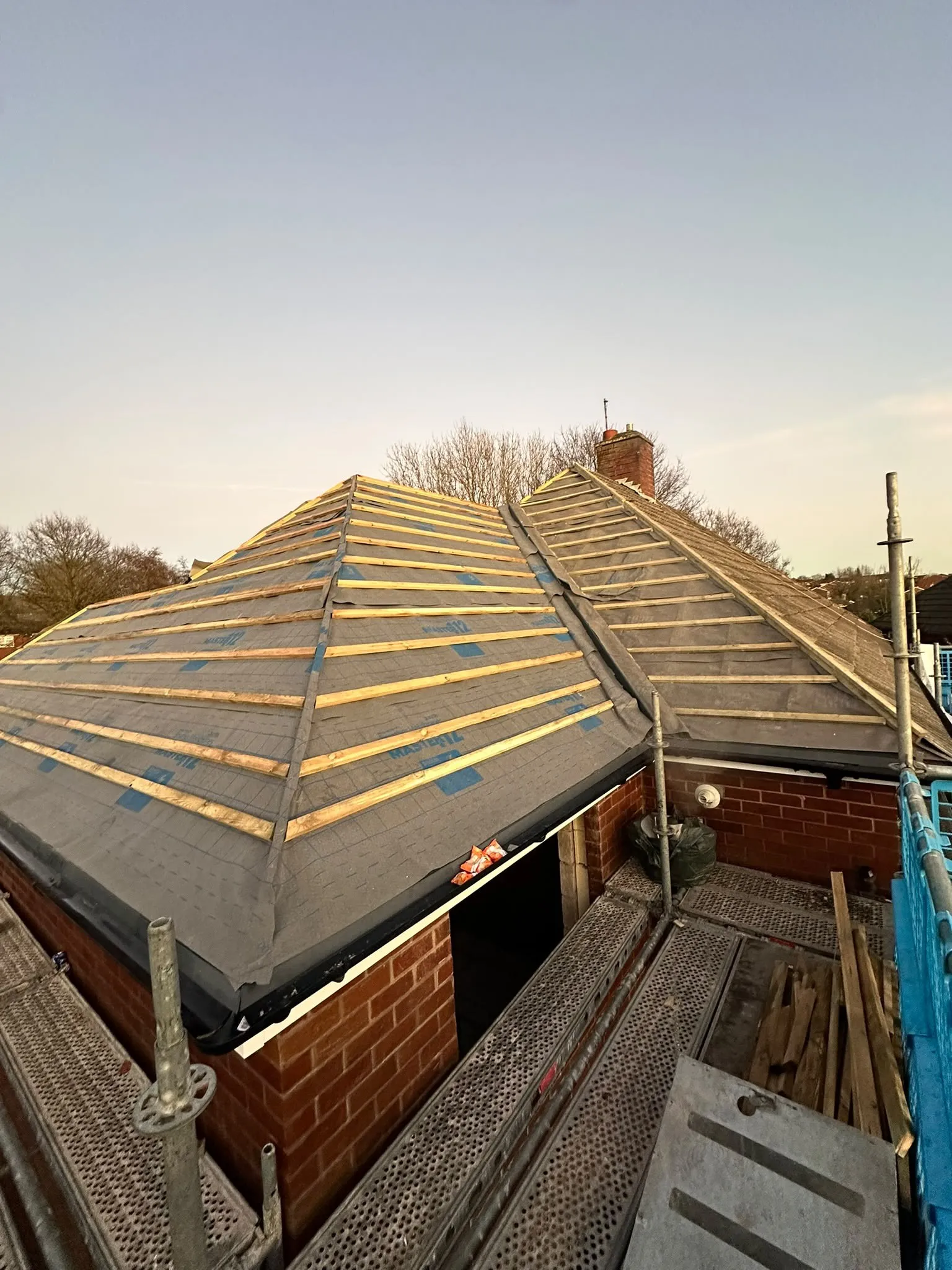 Hipped roof covered in membrane and new battens, ready for tiles