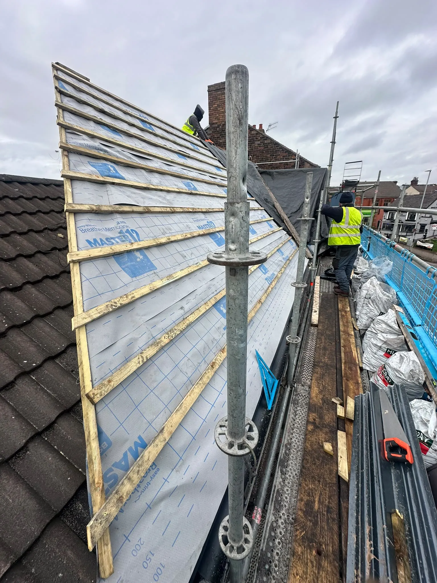 Roof slope with new membrane and timber battens, seen from scaffolding